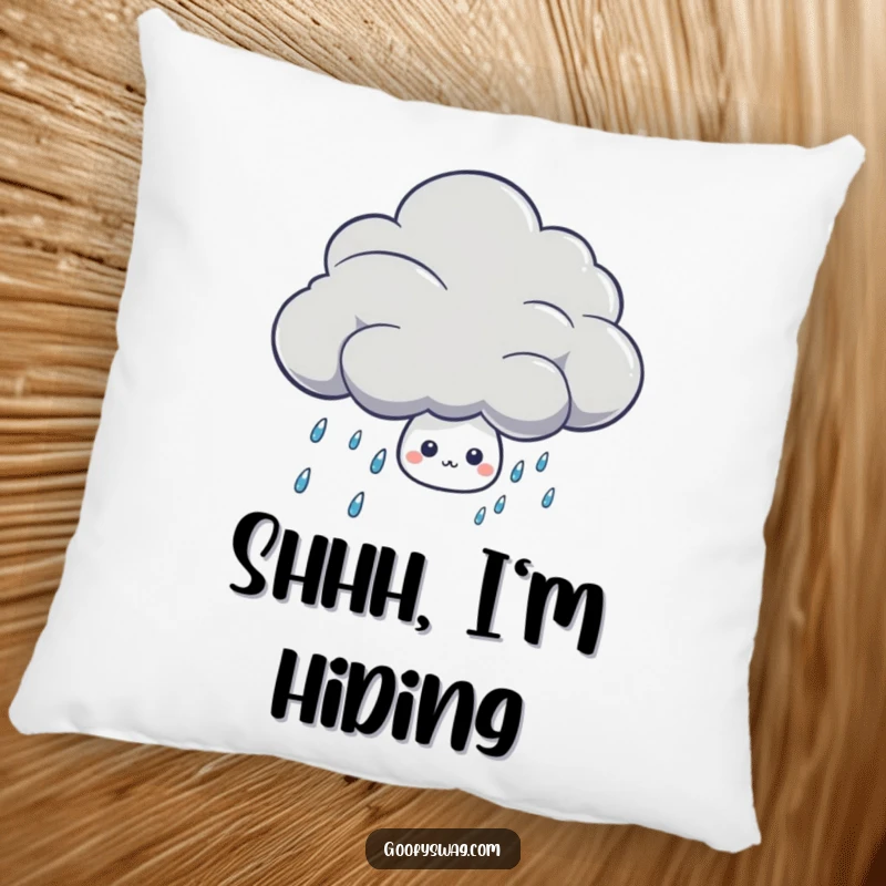 Funny shy rain drop character hiding behind a thunder cloud on a soft, decorative pillow.