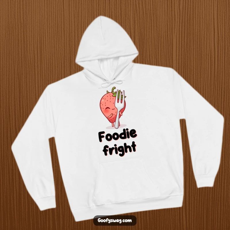 Comfortable funny hoodie featuring a blushing strawberry hiding shyly behind a giant fork, a heartwarming and humorous design.
