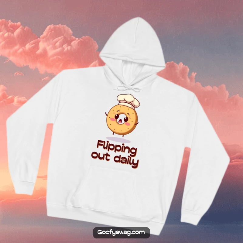 Funny hoodie featuring a surprised bagel in a chef hat attempting to flip, perfect for cozy kitchen laughs.