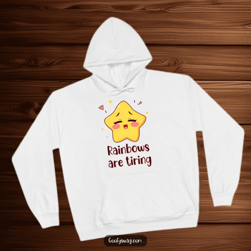 Funny sleepy star character yawning rainbows while attempting to blink, on a warm and humorous hoodie.