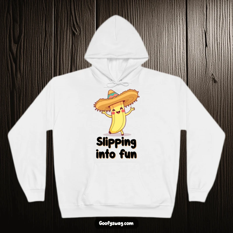 Funny hoodie featuring a banana peel in a sombrero doing the cha-cha, perfect for festive occasions and lovers of quirky humor.