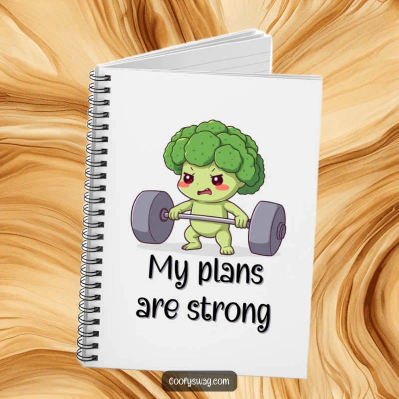 Funny notebook with a determined broccoli floret lifting a heavy weight, ideal for planning workouts and healthy meals with a humorous touch.